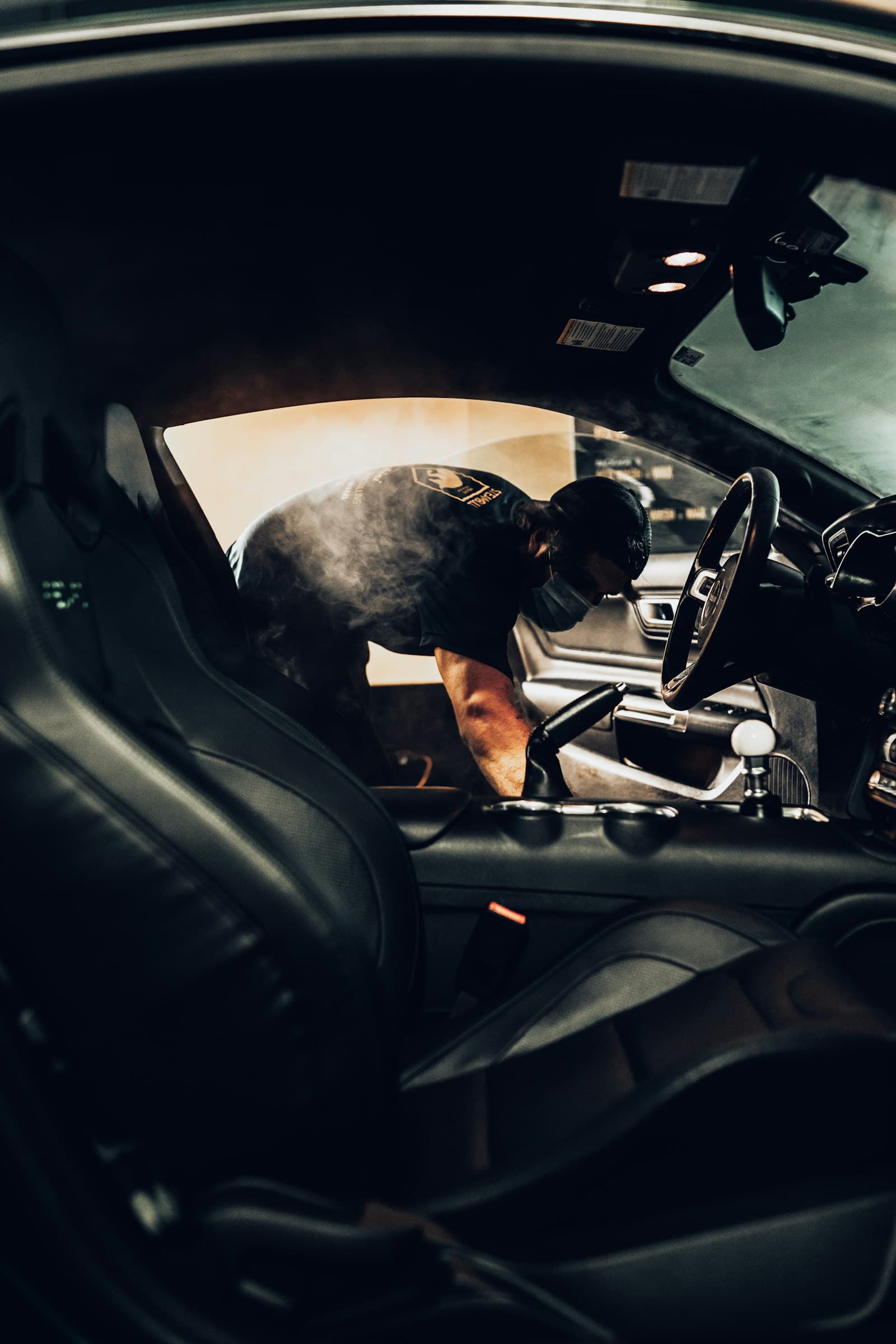 A detailer at work on a car interior