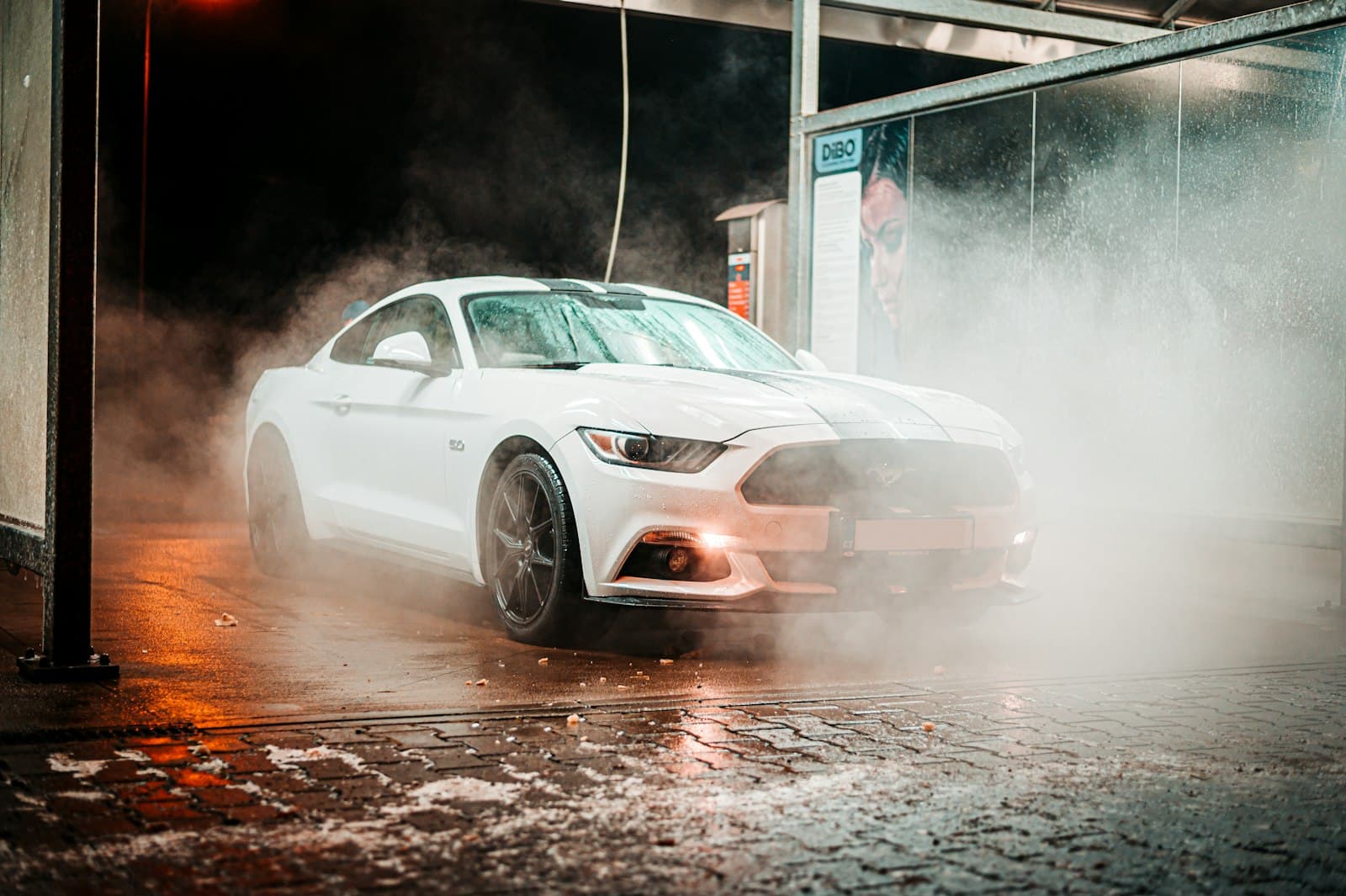 A car emerging from steam with a protected, glossy finish