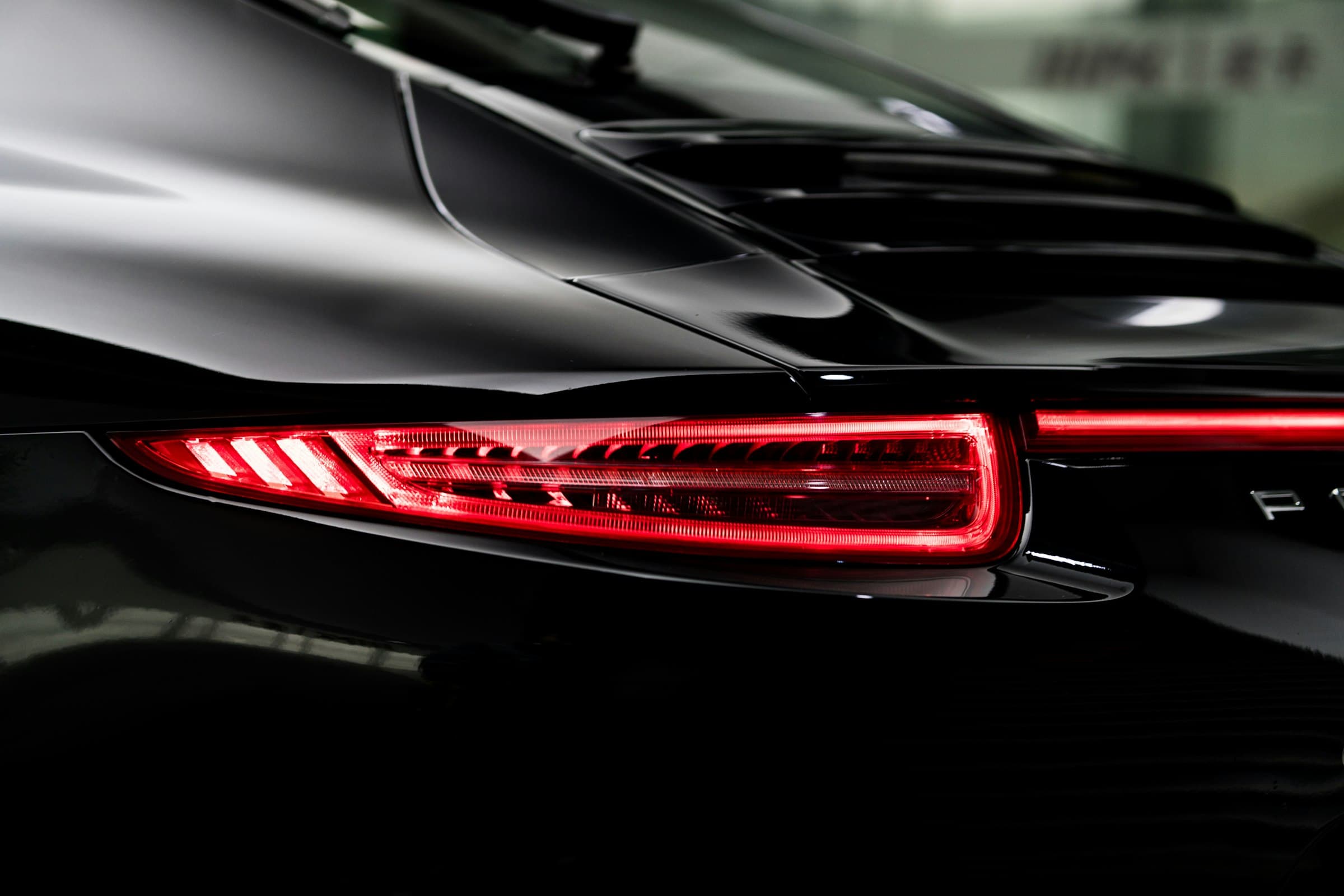 A freshly detailed dark car with a deep, reflective gloss finish