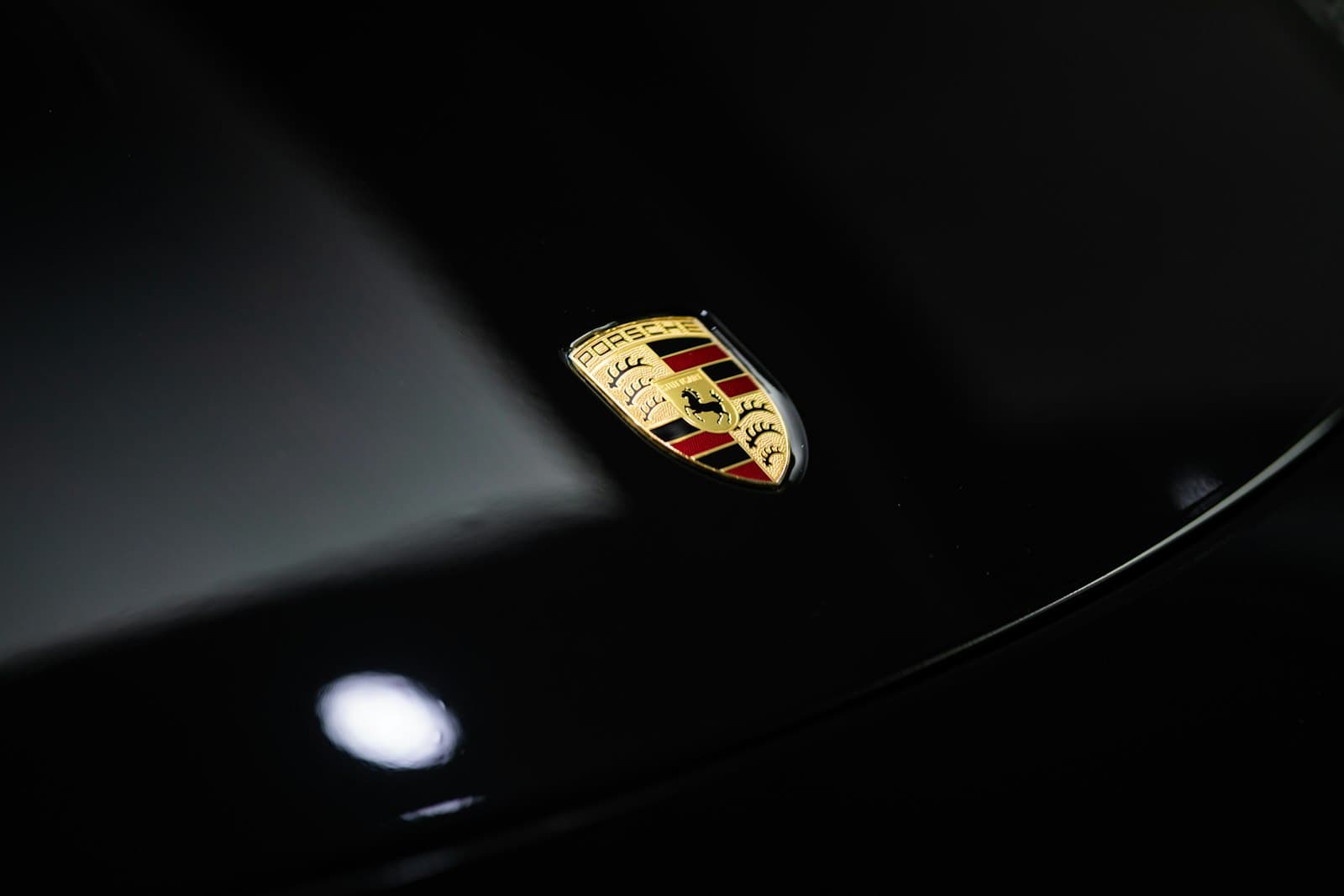Light raking across a polished black car panel